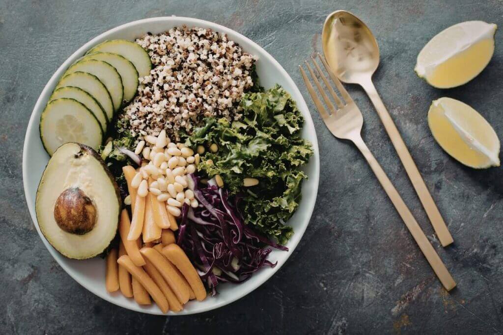 Healthy quinoa bowl with avocado, cucumber, and fresh greens for a weight loss diet plan.